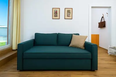 a blue couch in a living room at Arena Penthouse Apartments in Belgrade