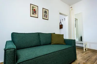 a green couch sitting in a living room at Arena Penthouse Apartments in Belgrade