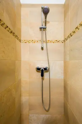 a shower with a shower head in a bathroom at Arena Penthouse Apartments in Belgrade