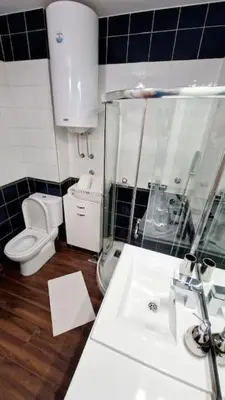 a bathroom with a toilet and a glass shower at Apartman Meri in Tošin Bunar