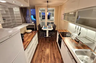 a kitchen with a sink and a table in it at Apartman Meri in Tošin Bunar
