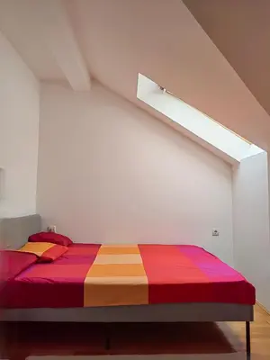 a bedroom with a bed with a colorful blanket at Duplex Delight in Belgrade