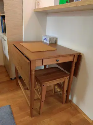 a wooden desk with a drawer and a box on it at Duplex Delight in Belgrade