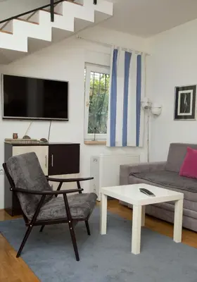 a living room with a couch and a table at Duplex Delight in Belgrade