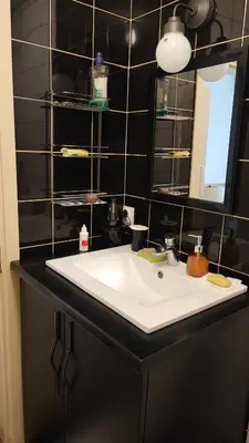a bathroom with a white sink and a mirror at Duplex Delight in Belgrade