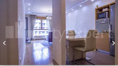 a kitchen with a counter and a table with chairs at Central Garden modern 1 bedroom condominium complex in Belgrade