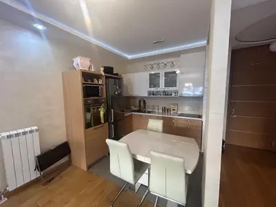 a kitchen with a white table and white chairs at Central Garden modern 1 bedroom condominium complex in Belgrade