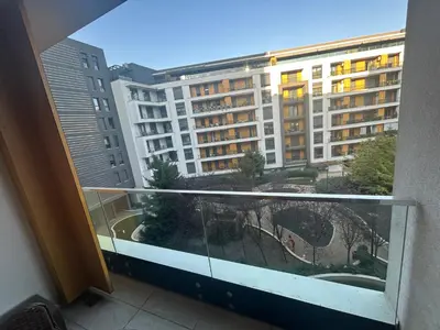 a balcony with a view of a large building at Central Garden modern 1 bedroom condominium complex in Belgrade