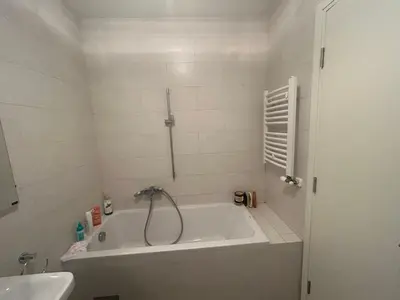 a white bathroom with a tub and a sink at Central Garden modern 1 bedroom condominium complex in Belgrade