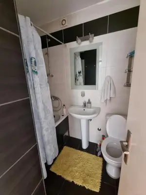 a small bathroom with a sink and a toilet at Ušće apartman in Novi Beograd