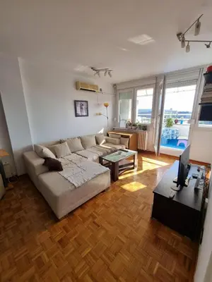 a living room with a couch and a table at Ušće apartman in Novi Beograd