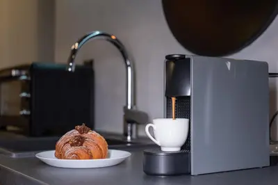 a pastry sitting on a counter with a cup of coffee at Apartment Knez Belgrade in Belgrade