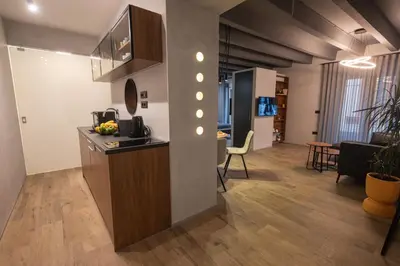 a kitchen and a living room with a table at Apartment Knez Belgrade in Belgrade