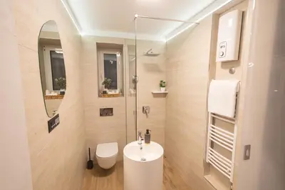 a bathroom with a white sink and a shower at Apartment Knez Belgrade in Belgrade