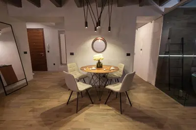 a dining room with a table and chairs and a mirror at Apartment Knez Belgrade in Belgrade