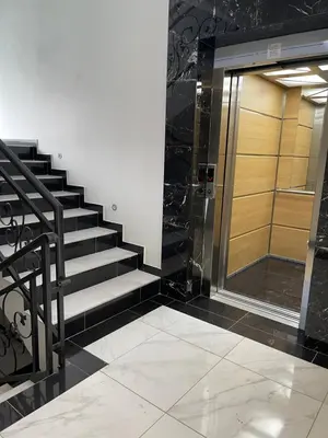 a staircase in a building with a glass door at Cvetanov trg LUX 3 in Belgrade