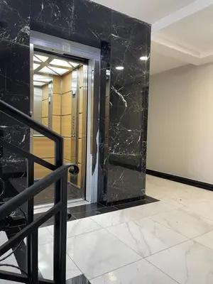 a lobby with a glass door with a marble wall at Cvetanov trg LUX 3 in Belgrade