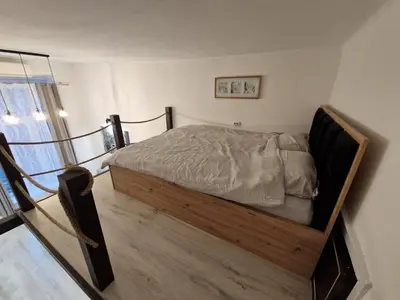 a bedroom with a bed with a wooden frame at Belgrade City Center Apartment in Belgrade