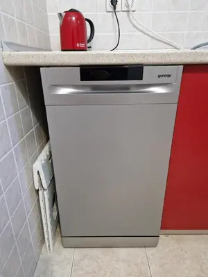 a red kettle on top of a dishwasher in a kitchen at Belgrade City Center Apartment in Belgrade