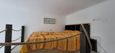 a bed in a room with a rope around it at Belgrade City Center Apartment in Belgrade