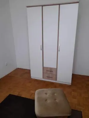 a room with two white cabinets and a stool at Sobe Aerodrom in Surčin