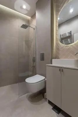 a bathroom with a toilet and a glass shower at Olive Apartments in Belgrade