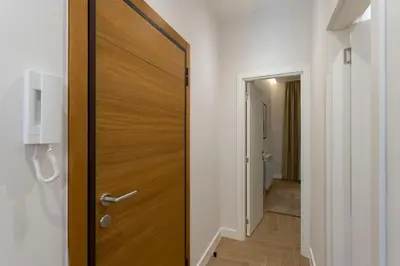 a wooden door in a room with a hallway at Olive Apartments in Belgrade