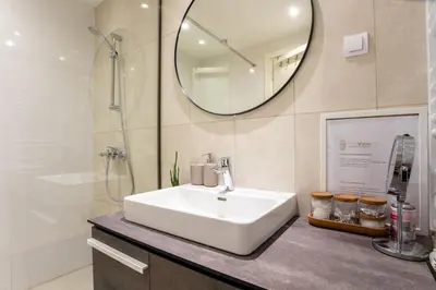 a bathroom with a white sink and a mirror at The View Belgrade Waterfront in Belgrade