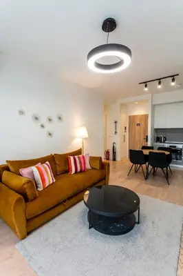 a living room with a couch and a table at The View Belgrade Waterfront in Belgrade