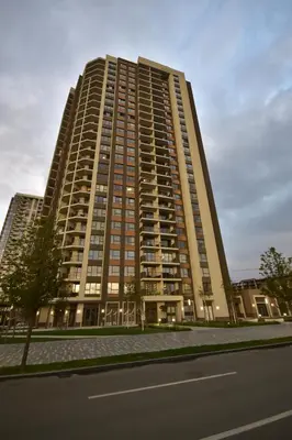 a tall building with a street in front of it at The View Belgrade Waterfront in Belgrade