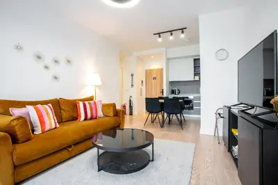 a living room with a couch and a table at The View Belgrade Waterfront in Belgrade