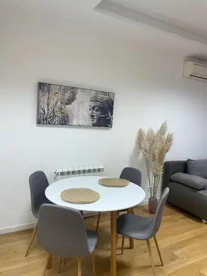 a dining room with a white table and chairs at Hedonist-Modern Urban Stay A Blok in Belgrade