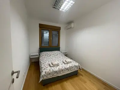 a bedroom with a bed with two shoes on it at Hedonist-Modern Urban Stay A Blok in Belgrade