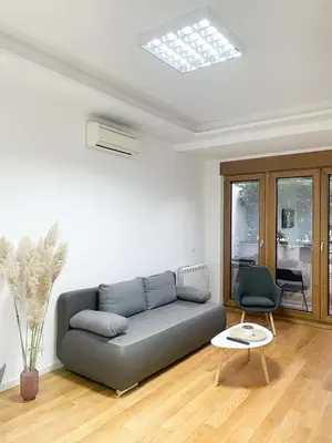a living room with a couch and a table at Hedonist-Modern Urban Stay A Blok in Belgrade