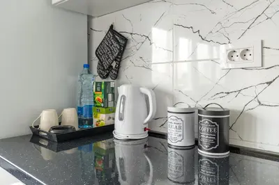 a kitchen counter with two coffee cups on it at Apartman Ivana in Novi Beograd