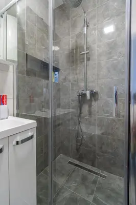 a shower with a glass door in a bathroom at Apartman Ivana in Novi Beograd