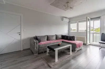 a living room with a couch and a table at Apartman Ivana in Novi Beograd