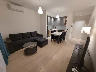 a living room with a couch and a table at Apartman IrMa in Sajmište