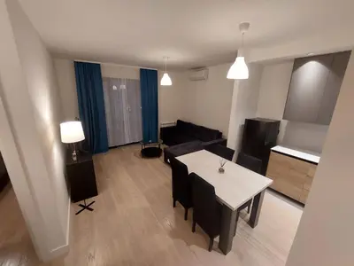 a living room with a table and a couch at Apartman IrMa in Sajmište