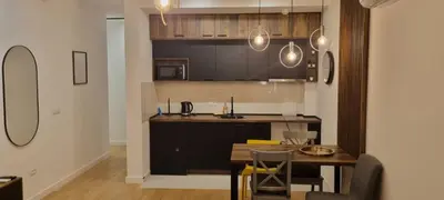 a kitchen with a table and a dining room at New luxury suite near St Sava Temple with garage in Belgrade