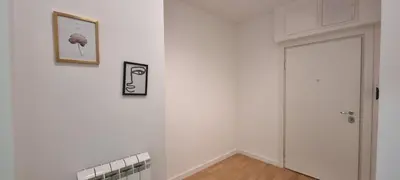 a white room with a door and a picture on the wall at New luxury suite near St Sava Temple with garage in Belgrade