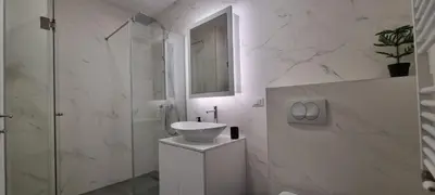 a white bathroom with a sink and a shower at New luxury suite near St Sava Temple with garage in Belgrade