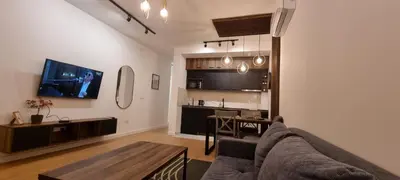 a living room with a couch and a table at New luxury suite near St Sava Temple with garage in Belgrade