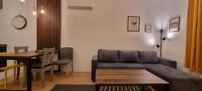 a living room with a couch and a table at New luxury suite near St Sava Temple with garage in Belgrade