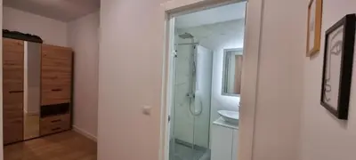 a bathroom with a shower and a sink and a mirror at New luxury suite near St Sava Temple with garage in Belgrade