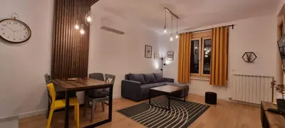 a living room with a couch and a table at New luxury suite near St Sava Temple with garage in Belgrade