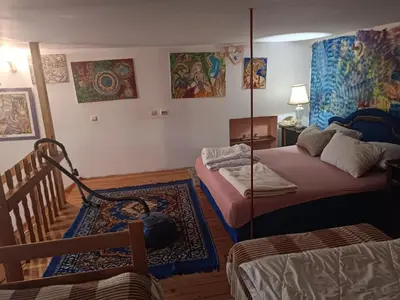 a room with two beds and a chair in it at Maravilja in Filmski Grad