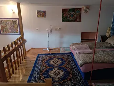 a room with a bed and a rug on the floor at Maravilja in Filmski Grad
