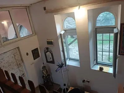 a room with three windows and a table and chairs at Maravilja in Filmski Grad