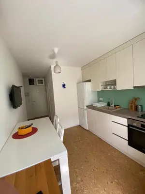 a kitchen with a white table with a cake on it at Goce 20 New Belgrade,near hotel Jugoslavija in Tošin Bunar